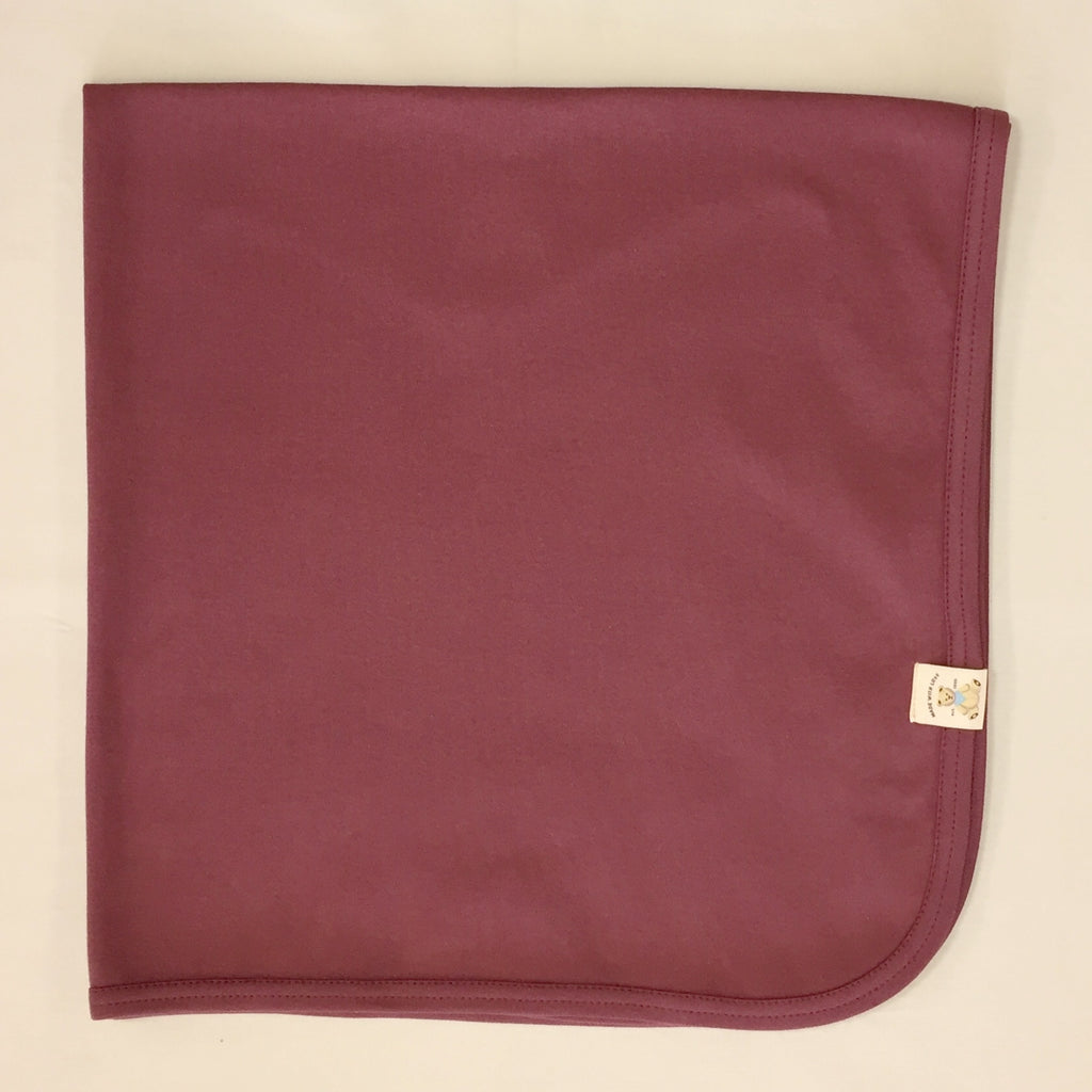 Minimalist cotton baby swaddle blanket in Crushed Berry. Made in Canada
