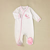 white baby sleeper with satin embroidery